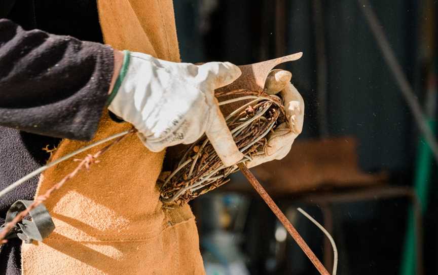 Ian Michael making a Lovebirds in a nest sculpture in his on-site workshop at Designer Dirt