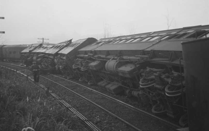 Railwayengineandcarriagesontheirsidesonthetrackafterbeinginvolvedinacollisionat Tamaree COctober1947