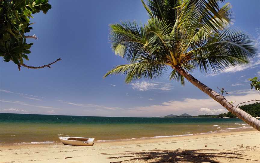 Timber boat on Bingil Bay beach looking south with Dunk Island, 2009.jpg