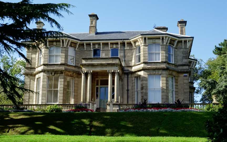 A photograph showing the 19th century bath stone manor house, overlooking the city of Newport and surrounded by the green spaces of the Park