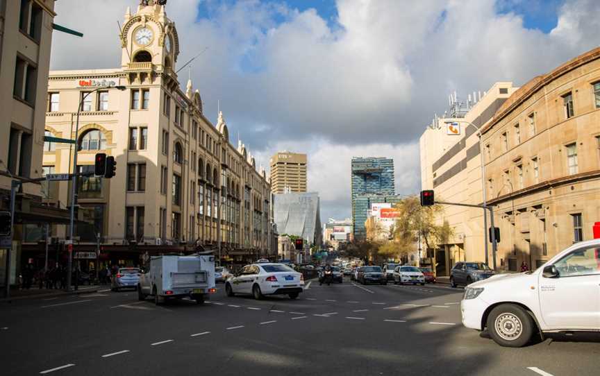 View down street with cars and trams