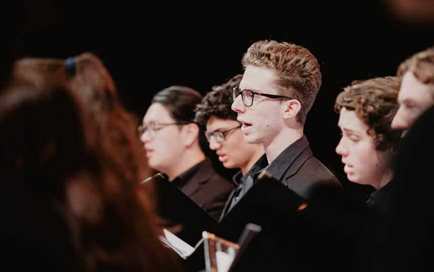 A choir of young people wearing black