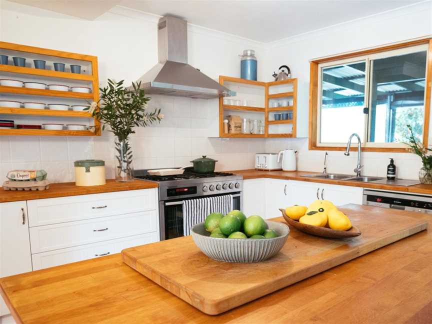 Galley-style kitchen with island bench and quality appliances.