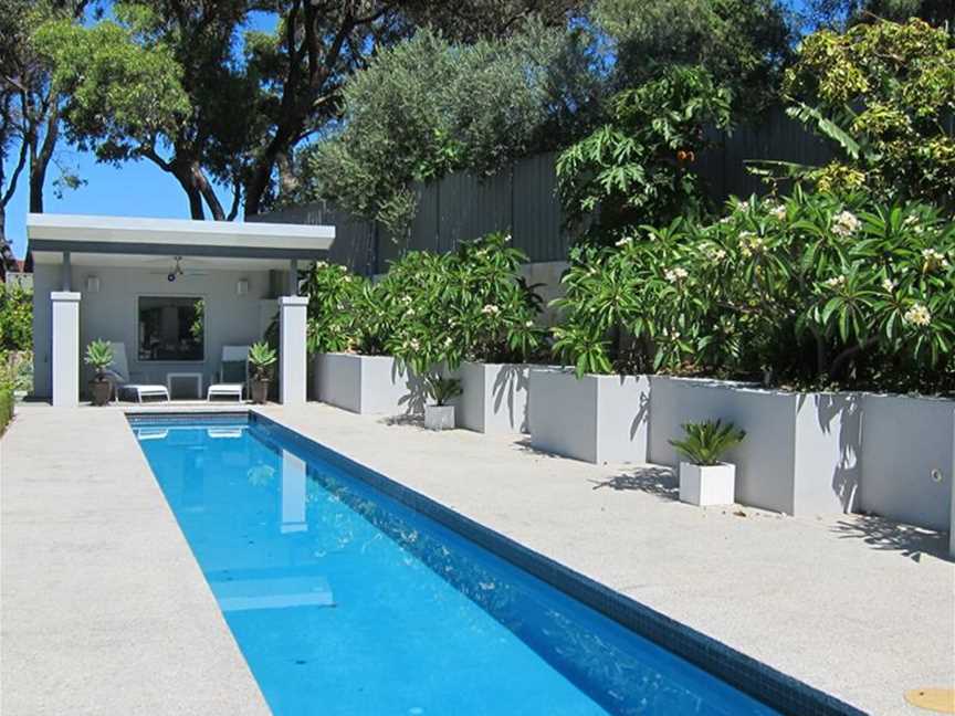 Lap pool with cabana, edged with frangipanis