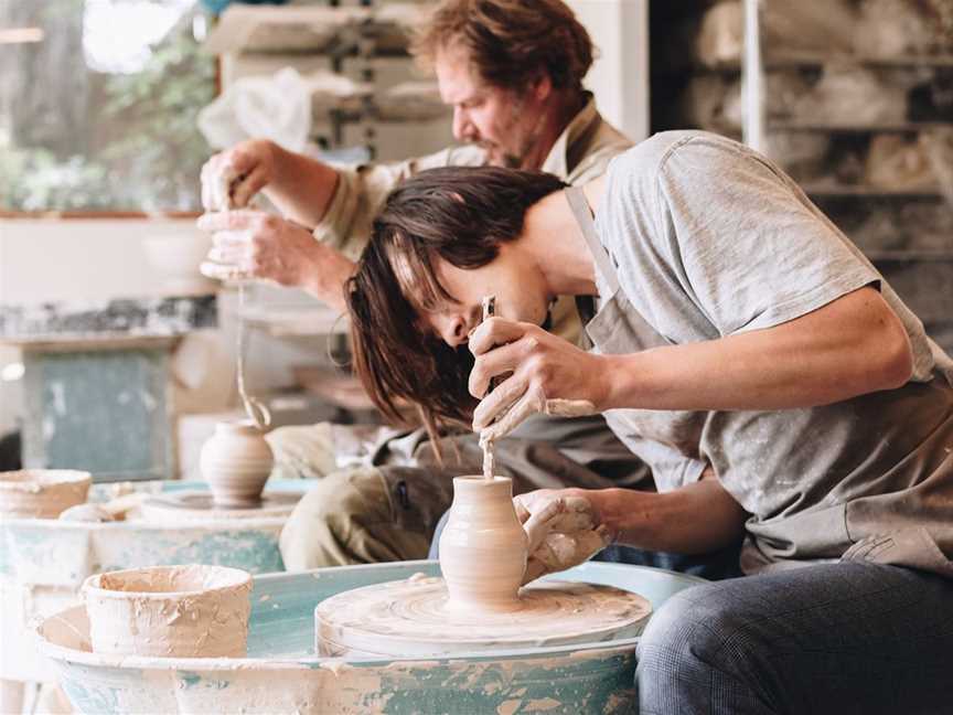 Father and son, Myles and Finn Happ make small bud vases.