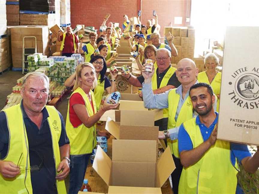 Volunteers packing hampers at Foodbank WA's warehouse