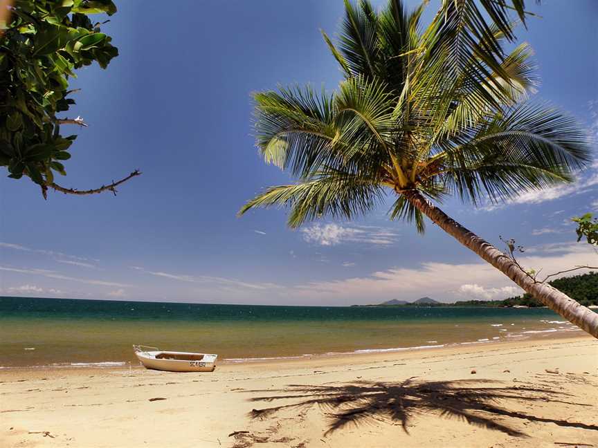 Timber boat on Bingil Bay beach looking south with Dunk Island, 2009.jpg