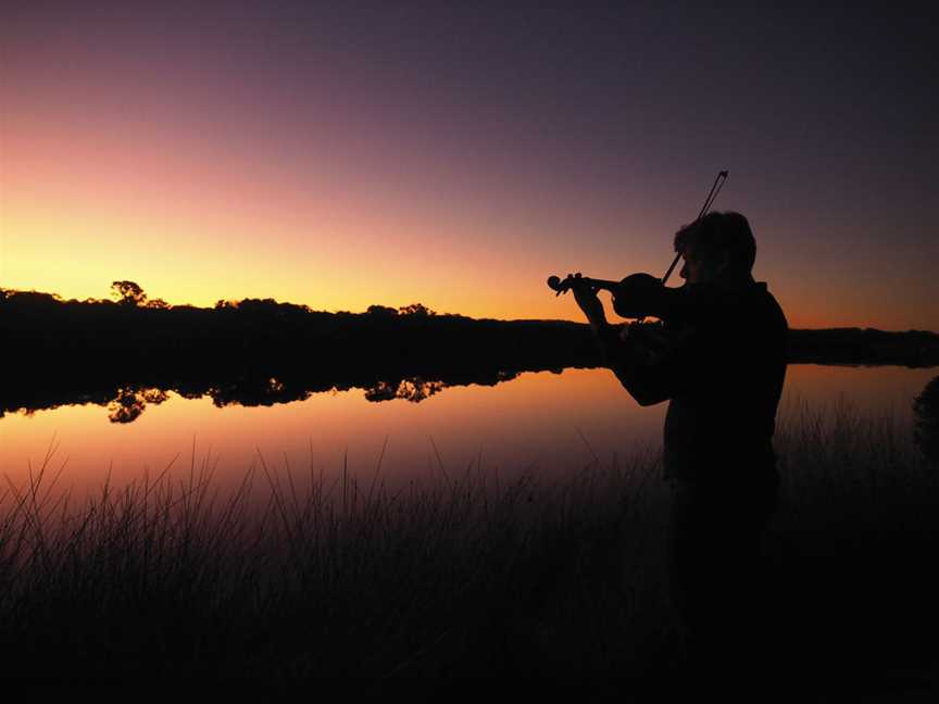 Robert Zielinski playing the violin at the Torbay Inlet at twilight